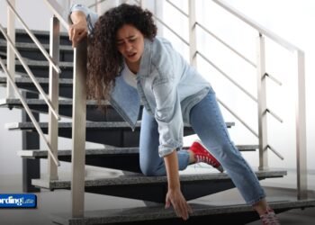 A woman falling on indoor stairs, illustrating common trip and fall accidents.